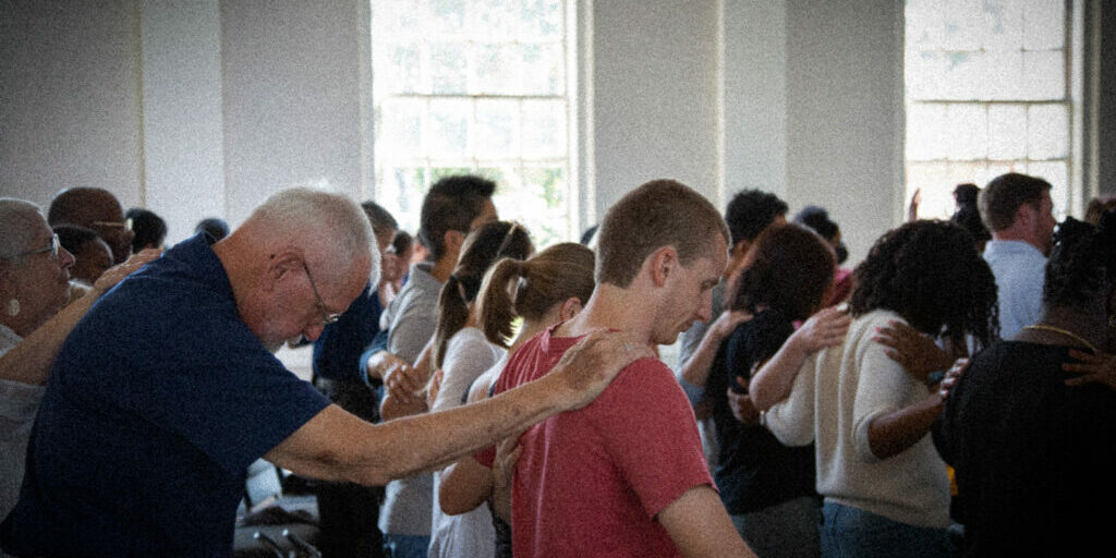 Photo of man praying for another man at Granite City Church Quincy, MA